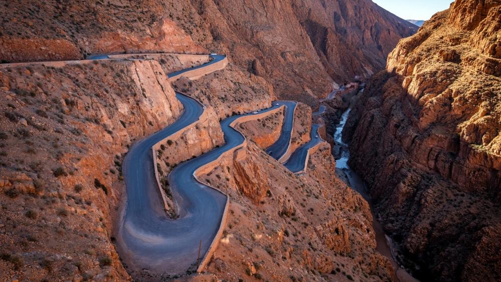 Winding Road Through Majestic Mountains wallpaper