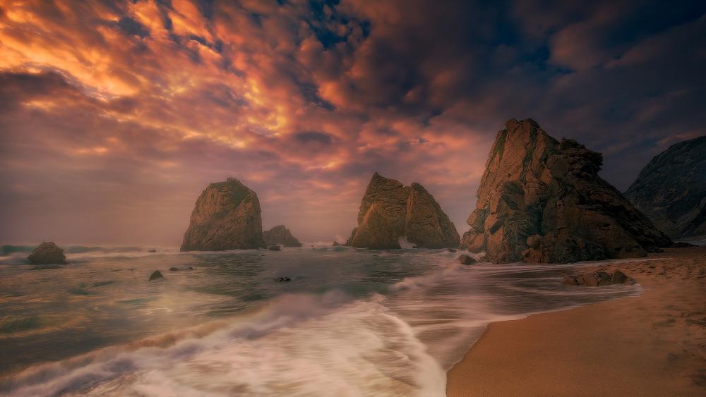 Majestic Coastal Sunset Over Serene Rocks wallpaper