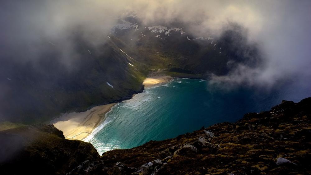 Majestic Coastal View Under Cloudy Skies wallpaper