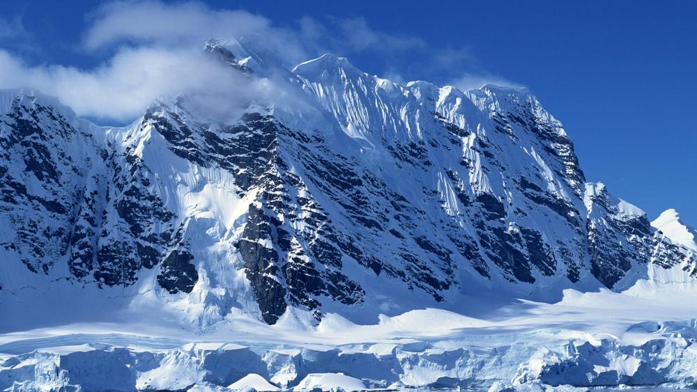 Majestic Snow-Capped Mountains Under Clear Skies wallpaper