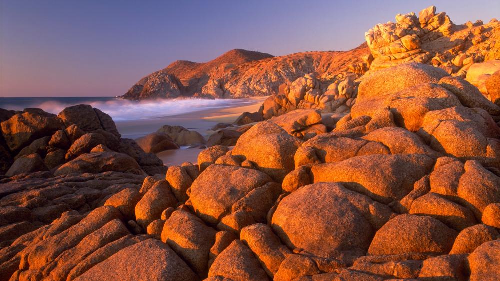Golden Sunset Over Rocky Coastline wallpaper