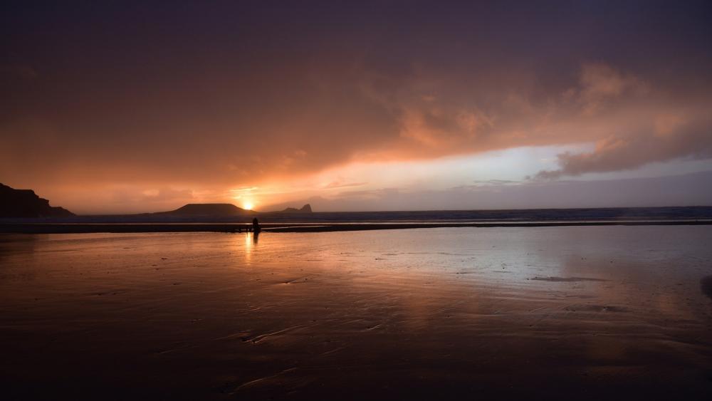 Serene Sunset at the Beach Illuminating the Horizon wallpaper