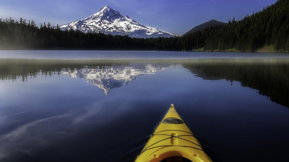 Serene Kayaking Adventure by Majestic Mountain Lake wallpaper