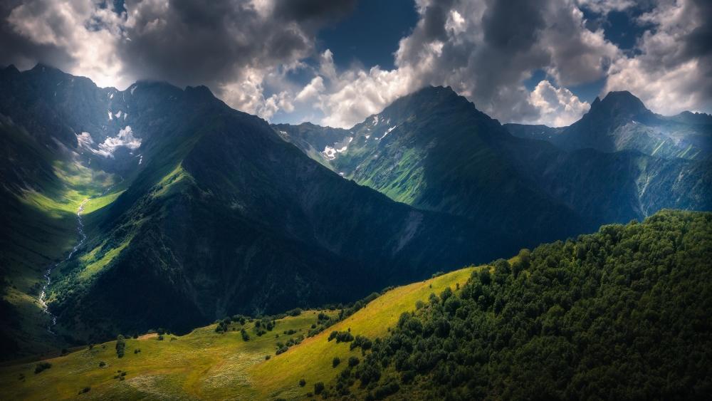 Majestic Mountain Landscape Under Dramatic Skies wallpaper