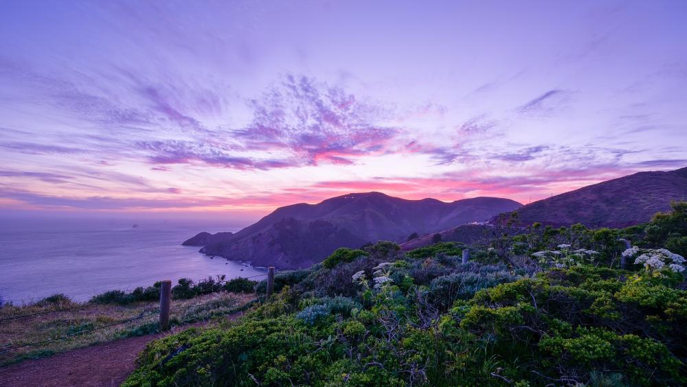 Serene Coastal Sunset Over Majestic Mountains wallpaper