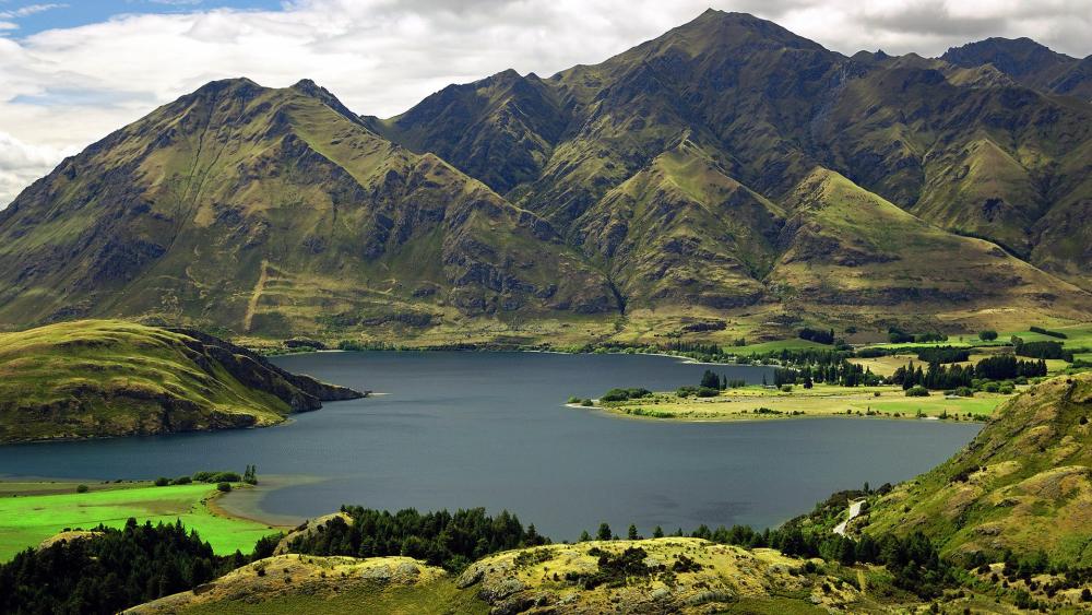 Majestic Mountains Reflecting in Tranquil Waters wallpaper