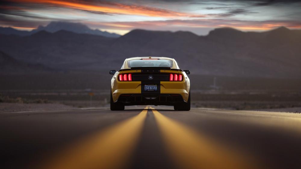 Bold Yellow Mustang on Open Road at Sunset wallpaper