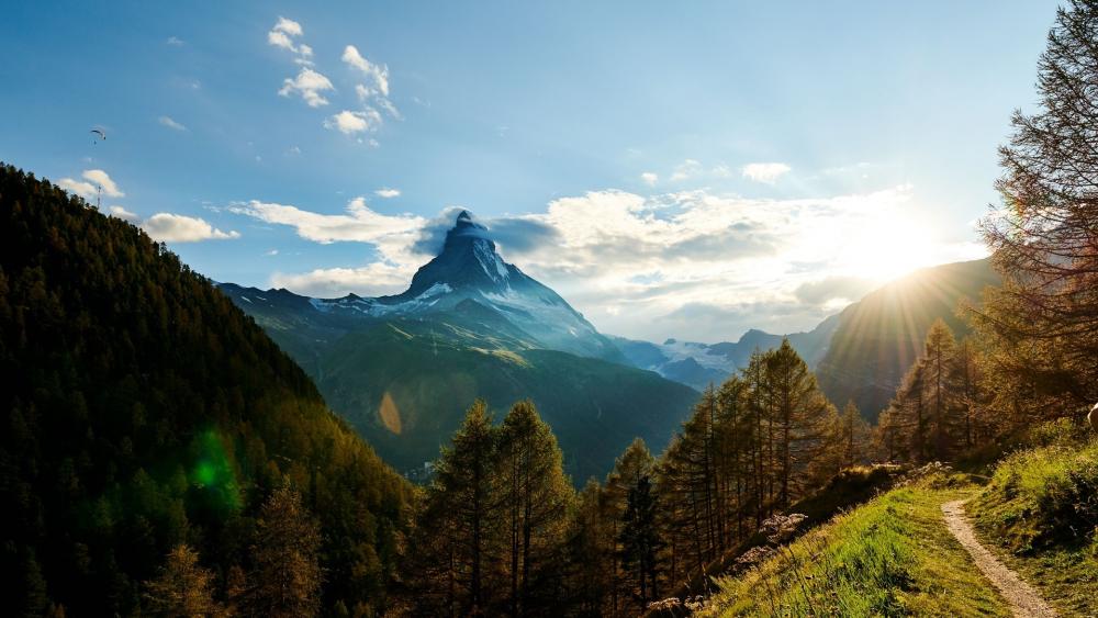 Majestic Mountain Sunrise Over Serene Landscape wallpaper