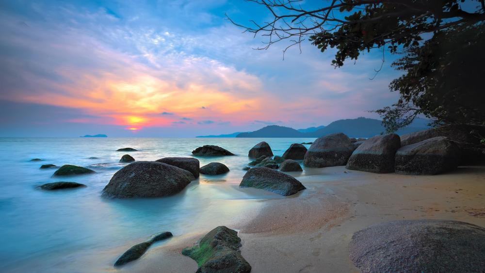 Serene Sunset Over Tranquil Beach wallpaper