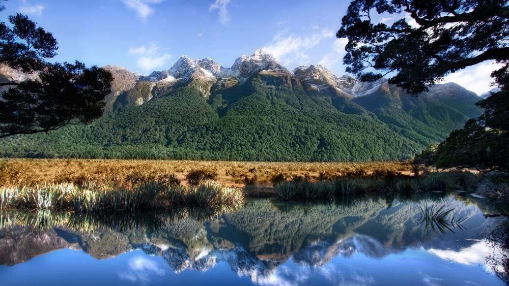 Majestic Mountains Reflecting in Tranquil Waters wallpaper