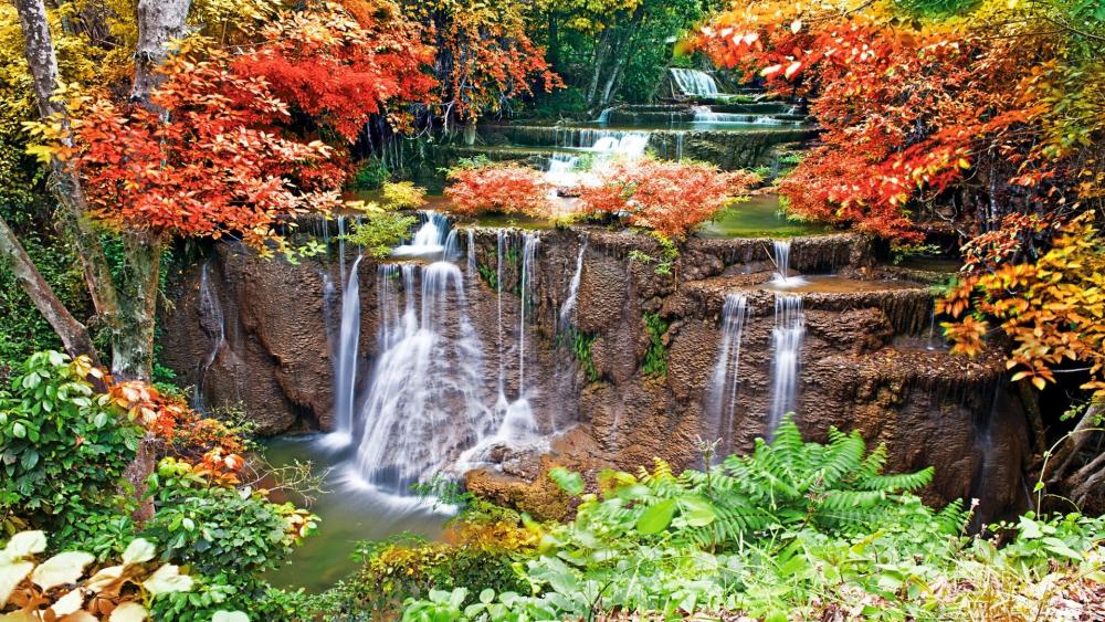 Serene Waterfalls Amidst Vibrant Autumn Foliage wallpaper