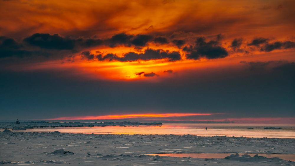 Dramatic Sunset Over Icy Waters wallpaper