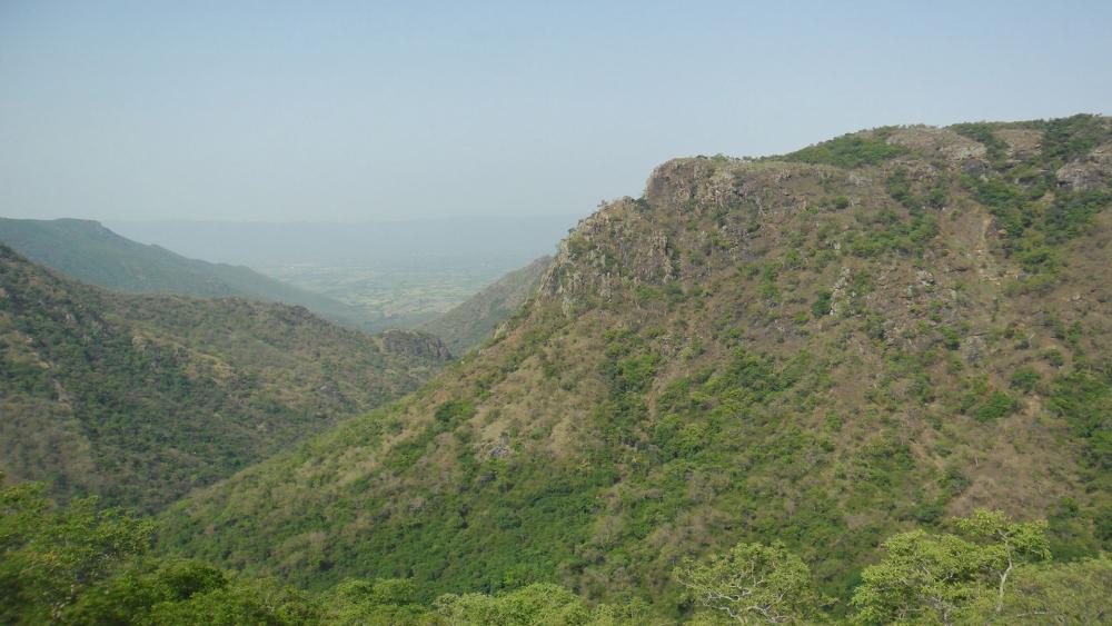 Majestic Green Mountains Under Clear Sky wallpaper