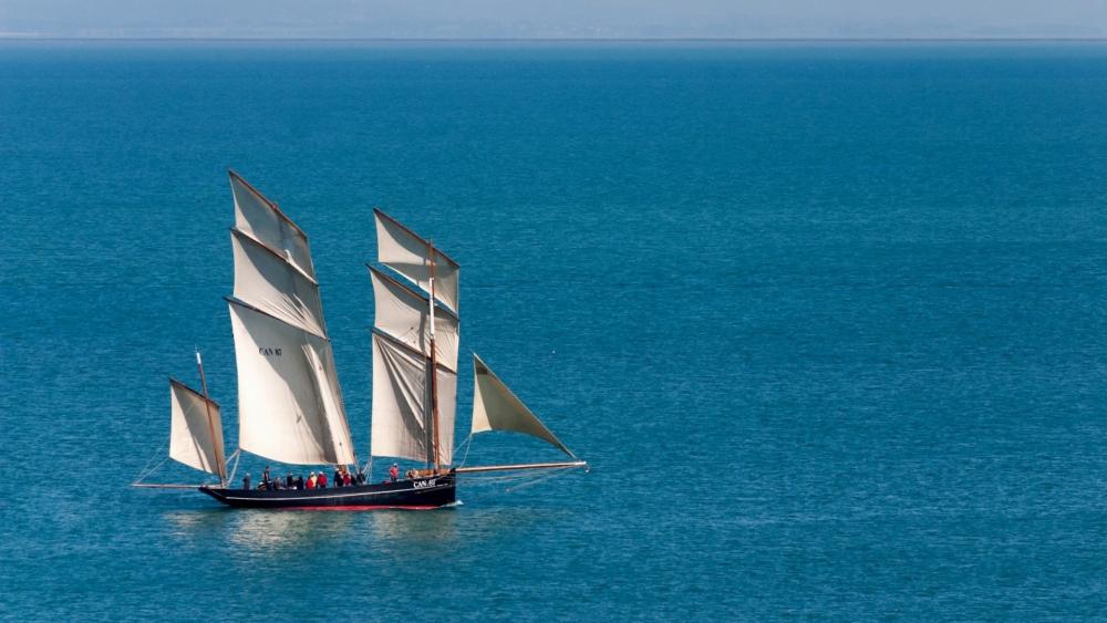 Tranquil Sailboat on Serene Waters wallpaper