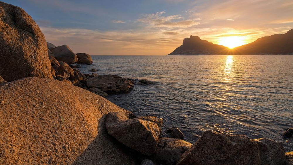 Golden Sunset Over Rocky Shoreline wallpaper
