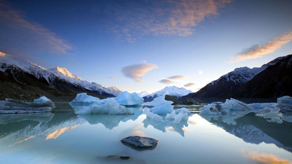 Serene Reflection of Icebergs in Tranquil Waters wallpaper