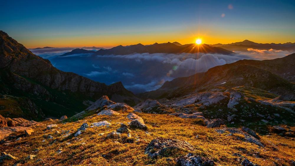 Majestic Sunrise Over Tranquil Mountains wallpaper