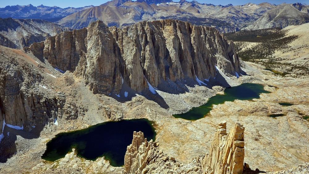 Majestic Mountain Landscape Beneath Clear Blue Skies wallpaper