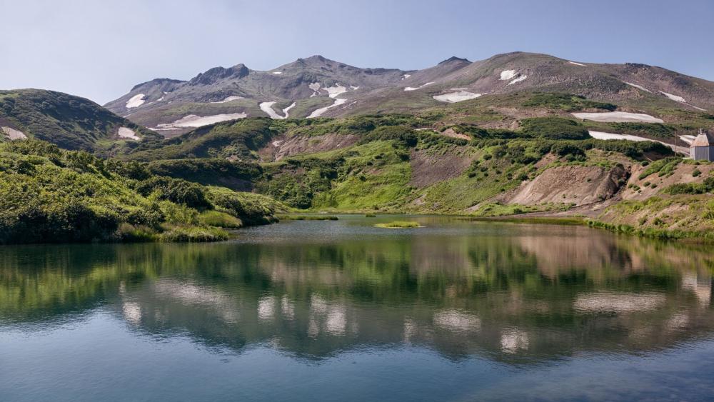 Serene Mountain Landscape with Reflective Water wallpaper