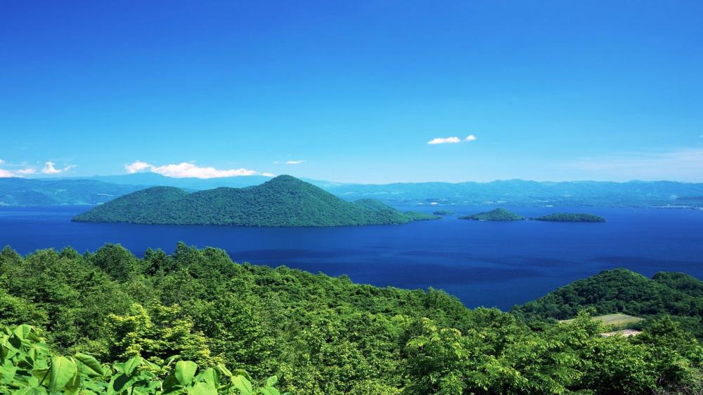 Serene Blue Waters and Lush Greenery Awaits Nature Lovers wallpaper