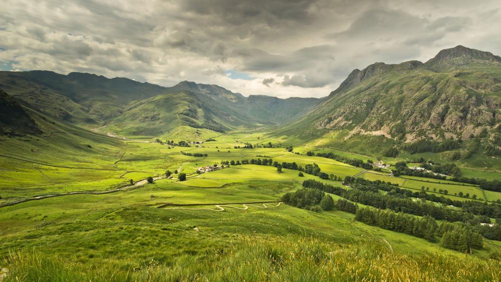 Majestic Valley Landscape Under Dramatic Skies wallpaper