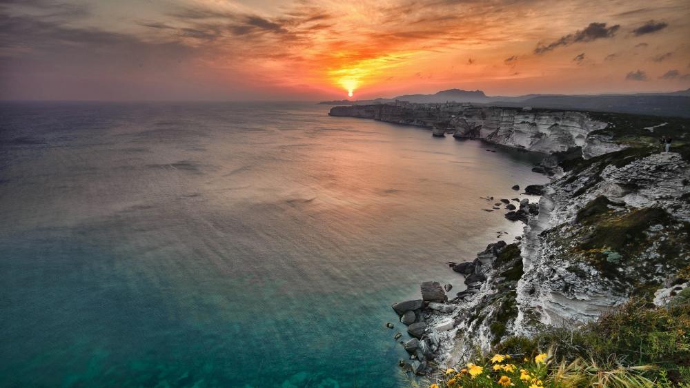 Serene Sunset Over Coastal Cliffs wallpaper