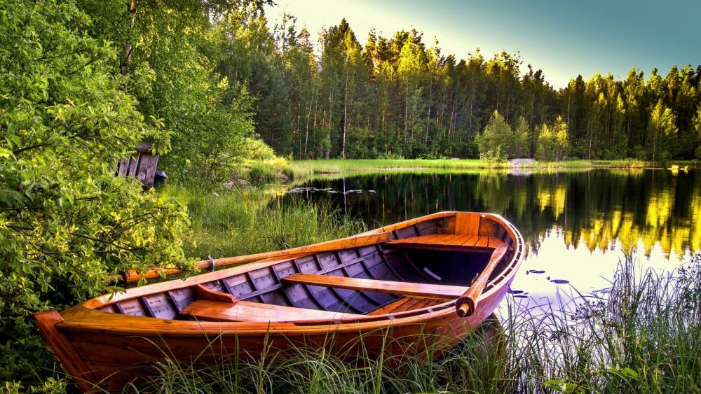 Tranquil Boat Scene Amidst Nature's Embrace wallpaper
