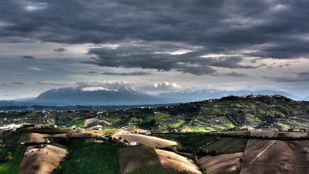 Majestic Landscape Under Dramatic Clouds wallpaper