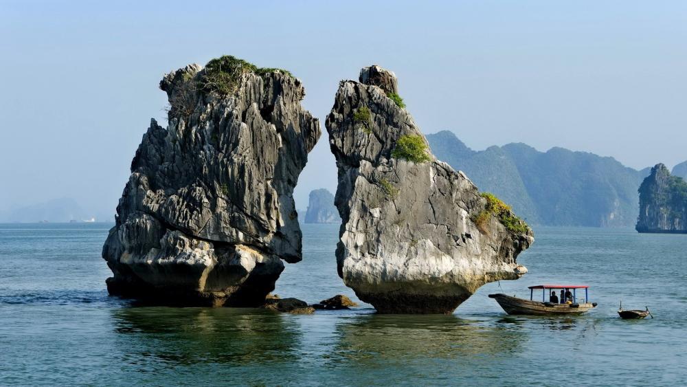 Majestic Rock Formation by Tranquil Waters wallpaper