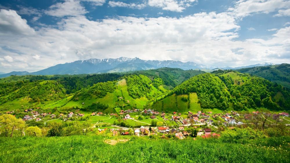 Breathtaking Mountain View Over Lush Green Hills wallpaper