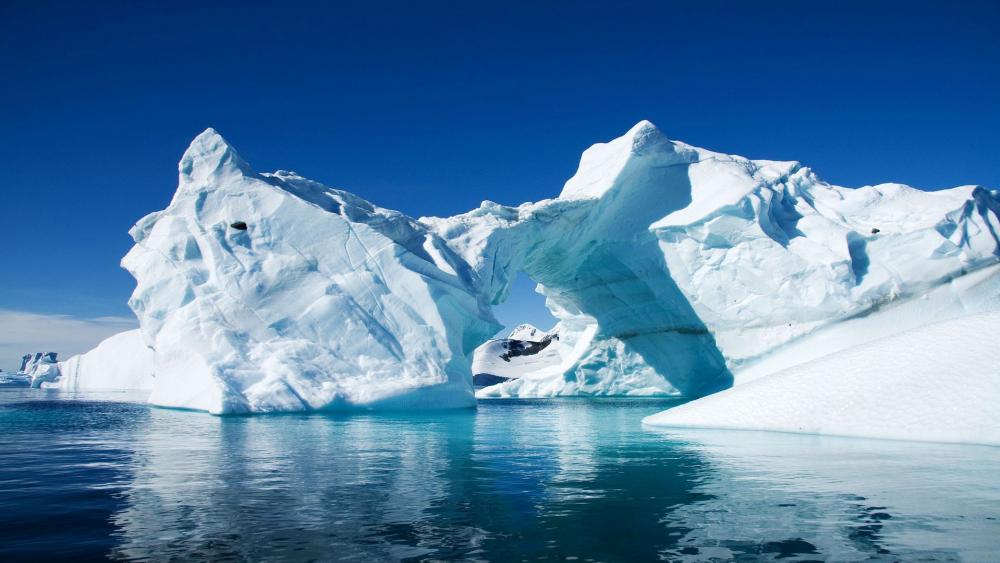 Majestic Ice Arch Under Clear Blue Sky wallpaper