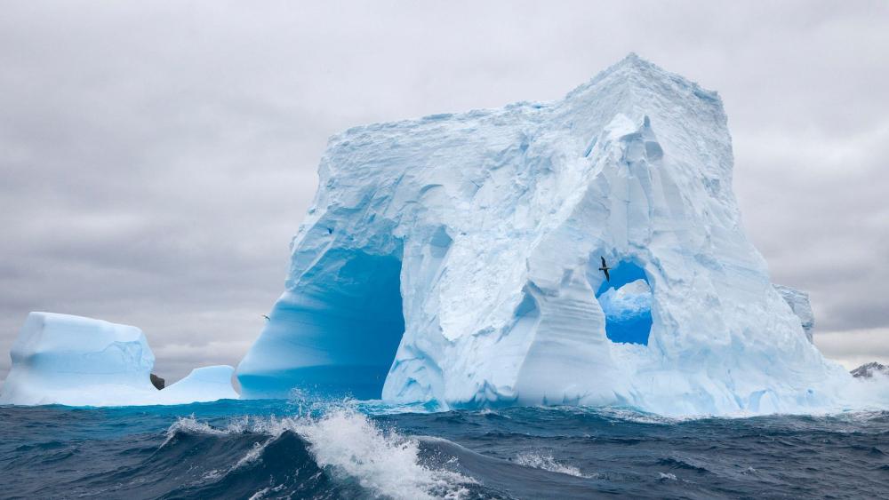 Majestic Iceberg against a Dramatic Sky wallpaper