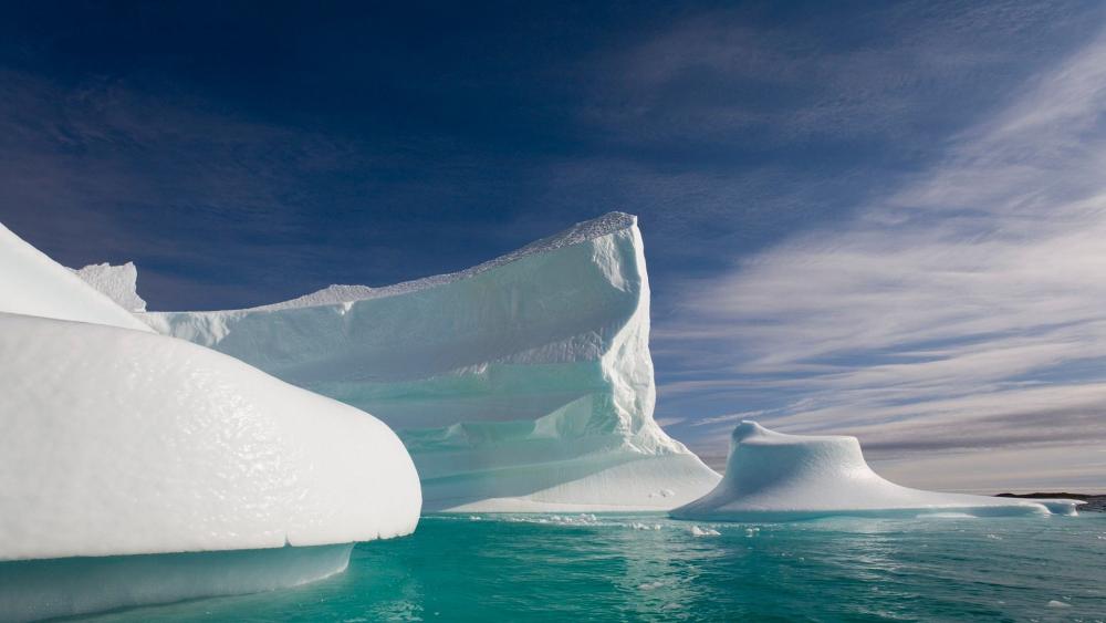 Majestic Icebergs Against a Serene Sky wallpaper