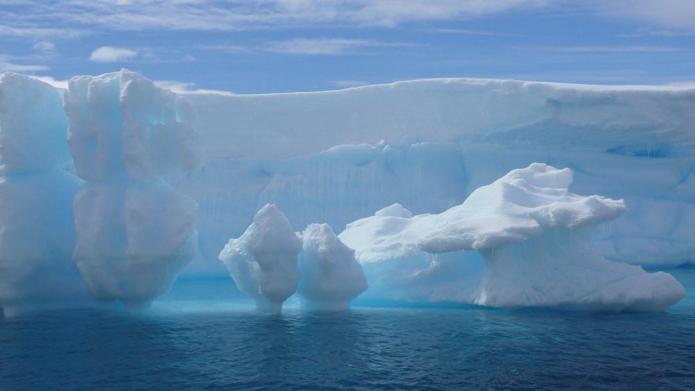 Majestic Icebergs in Tranquil Waters wallpaper