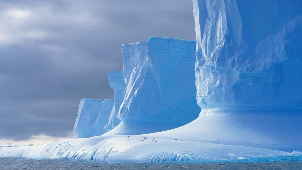 Majestic Glacial Formations in Icy Blue Waters wallpaper