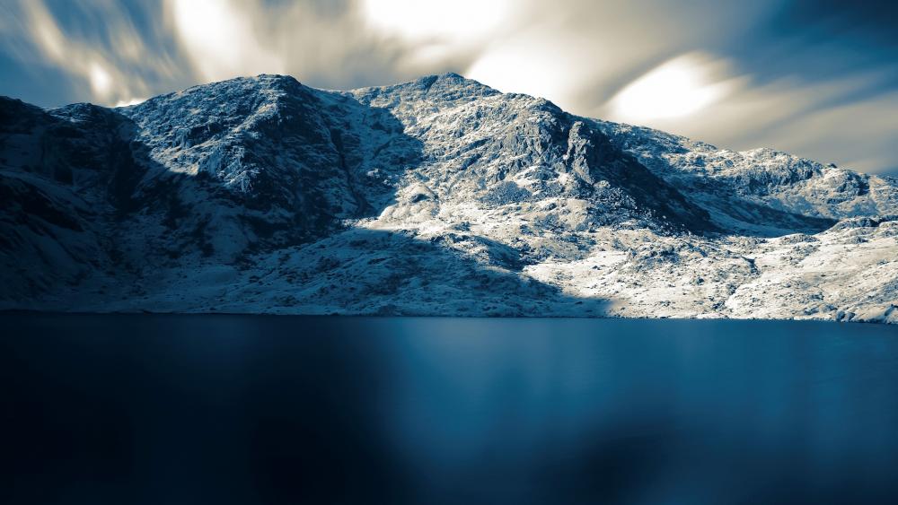 Majestic Snow-Covered Mountains Illuminated by Soft Light wallpaper