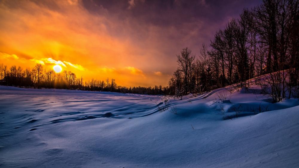 Winter Sunset Over Snowy Landscape wallpaper