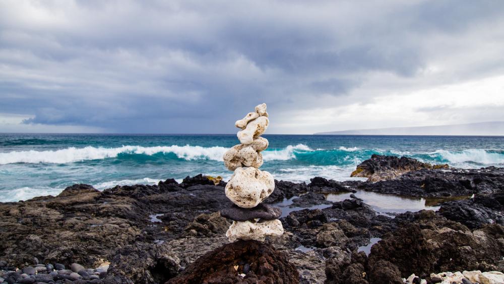 Balanced Stones on Rocky Shoreline wallpaper