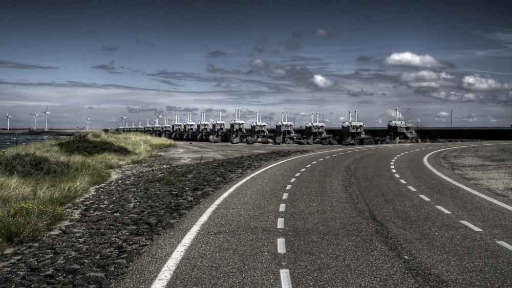 Tractors Aligned on Scenic Coastal Road wallpaper