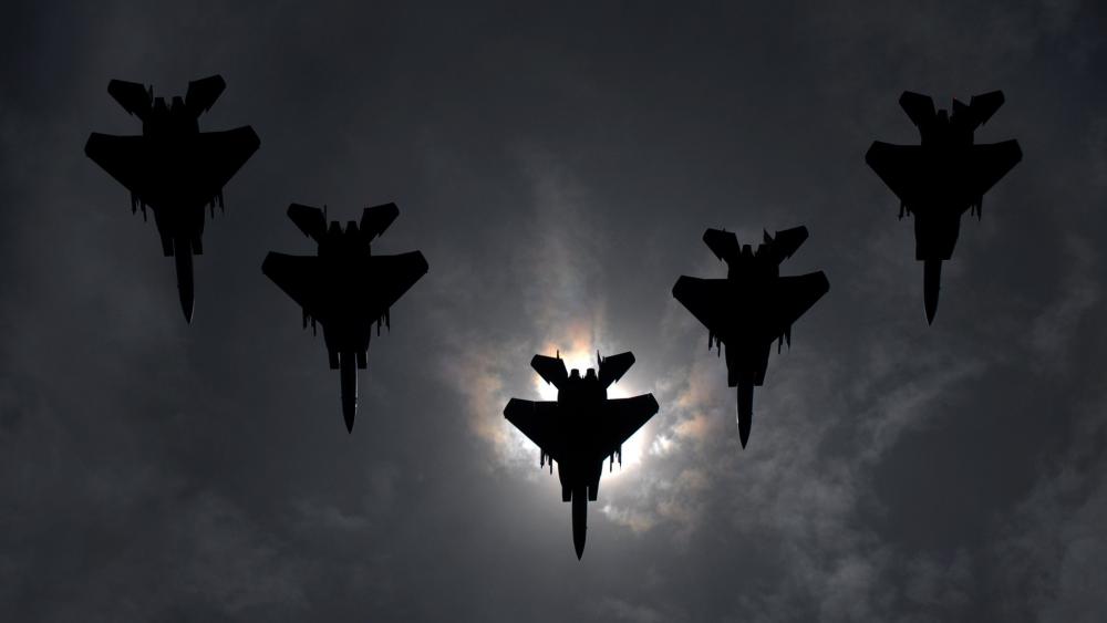 Silhouetted Fighter Jets In Formation wallpaper