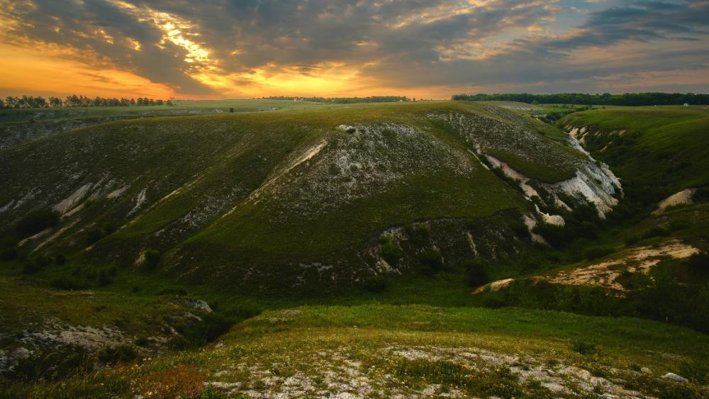 Majestic Sunset Over Rolling Hills wallpaper