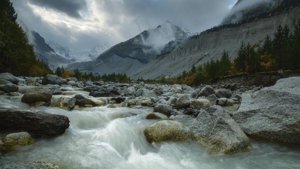 Serene Mountain Stream in Tranquil Landscape wallpaper