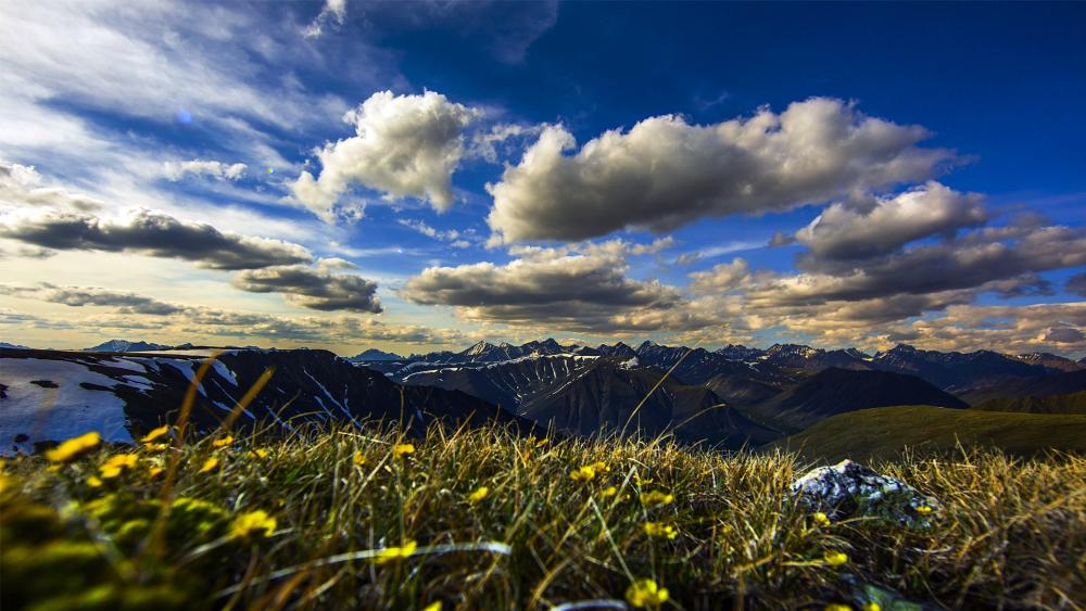Breathtaking Mountain Landscape Under Dramatic Clouds wallpaper
