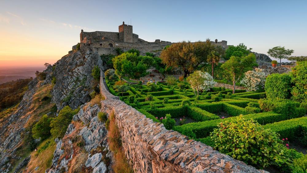 Majestic Castle Nestled Among Lush Gardens wallpaper