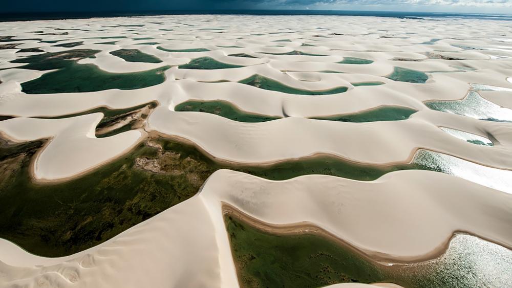 Serene Aerial View of Sand Dunes and Water Bodies wallpaper