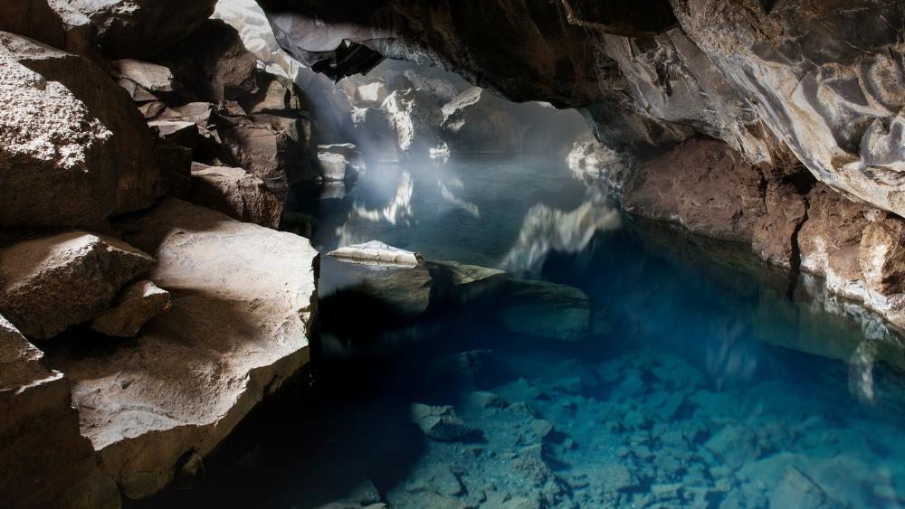 Serene Cave Pool with Misty Atmosphere wallpaper