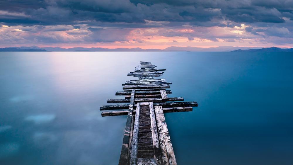 Serenity of an Abandoned Pier Overlooking Calm Waters wallpaper