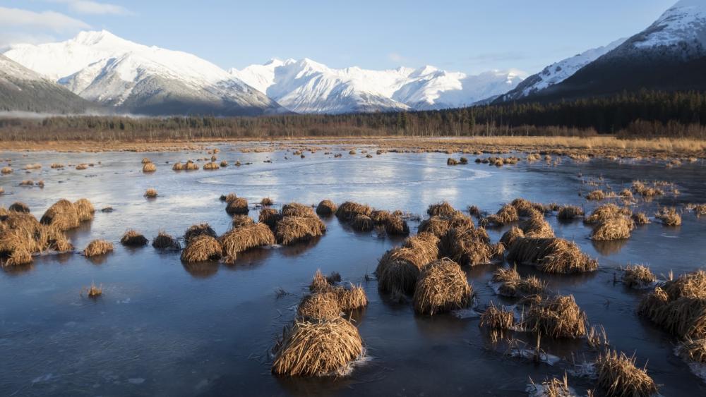Serene Winter Landscape with Mountains and Frozen Lake wallpaper