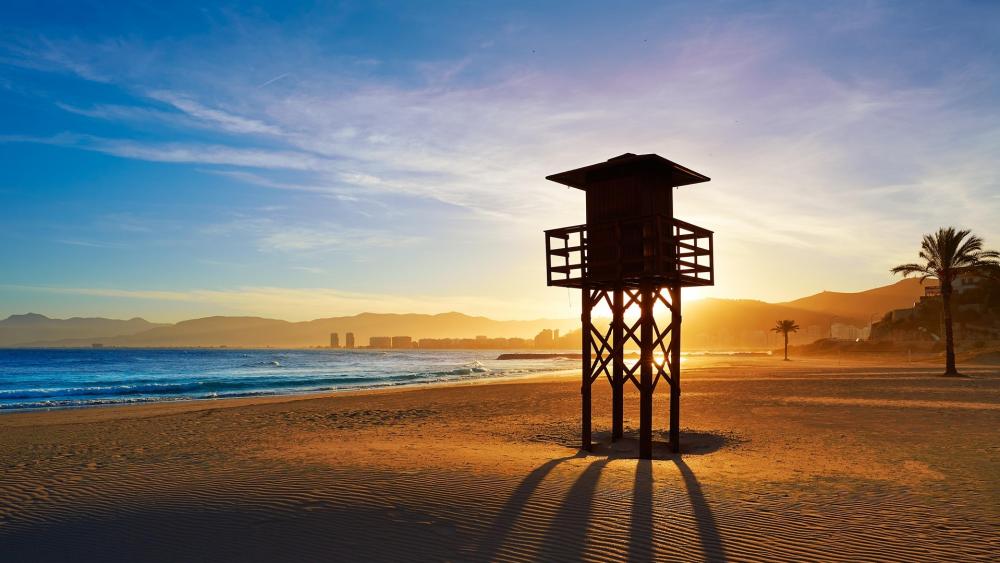 Peaceful Sunrise Over Beach Lifeguard Tower wallpaper