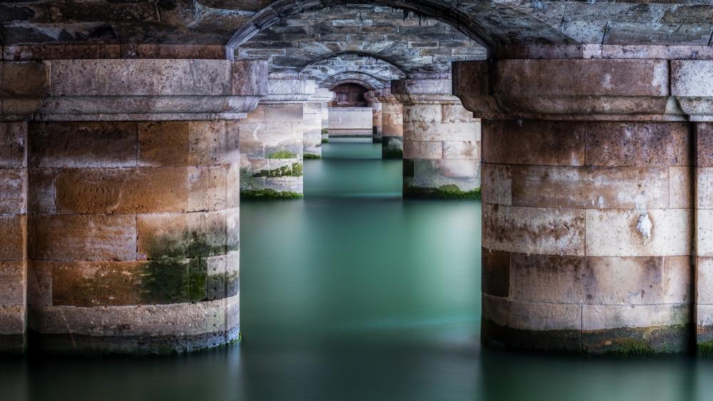 Serene Waters Beneath Ancient Archways wallpaper